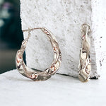 Twist of Elegance: High-Polish Rhodium-Plated Brass Hoop Earrings