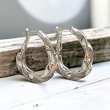 Twist of Elegance: High-Polish Rhodium-Plated Brass Hoop Earrings