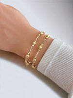 18K Gold  Beads beside 2mm Crystal Beaded Bracelets